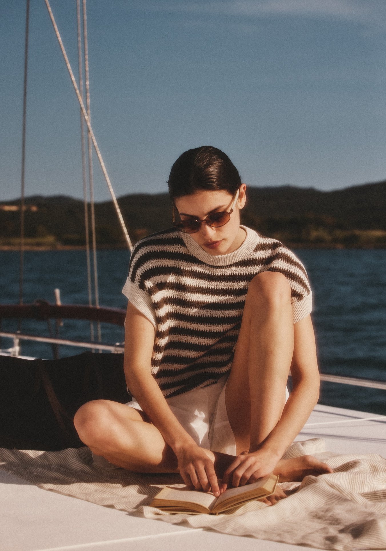 A women reading book on yacht